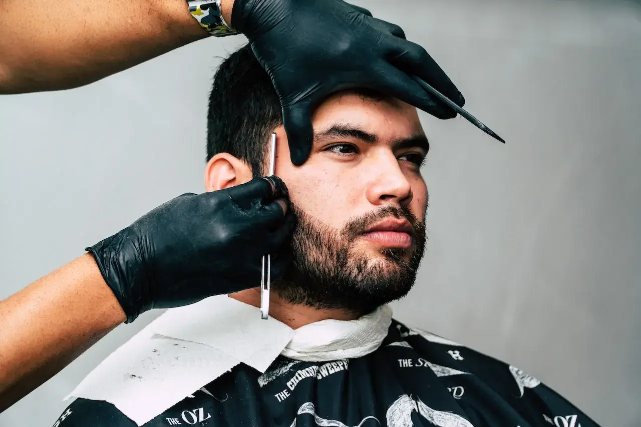 skilled expert cutting a costumer hair